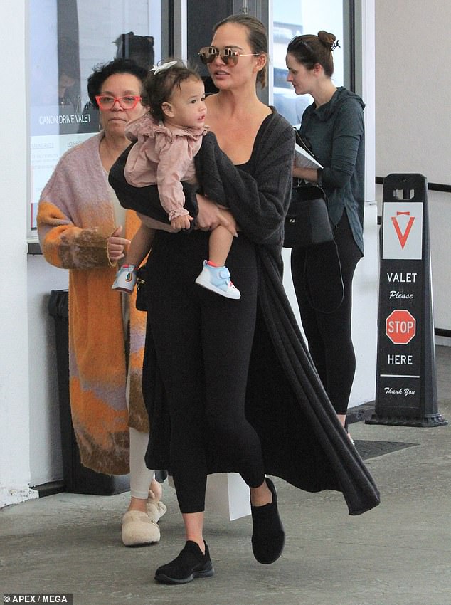 Chrissy Teigen enjoyed some downtime in Los Angeles on Thursday after a recent work vacation.  The model, 38, looked relaxed as she held her 14-month-old daughter Esti after a visit to a spa in Los Angeles.