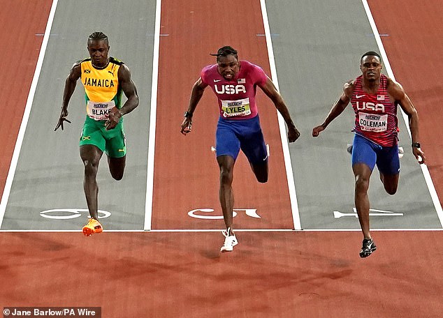 Christian Coleman (right) defeated Noah Lyles (center) to claim gold in the men's 60 meters final at the World Indoor Athletics Championships on Friday.