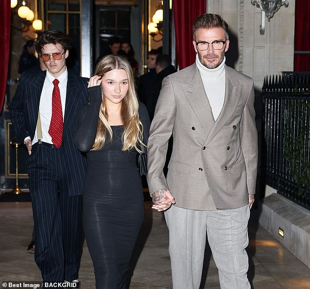 David Beckham, 48, was spotted as he and his family headed to support his wife Victoria at her Paris Week show in the French capital on Monday (David pictured with daughter Harper, 12, and his son Cruz, 19).