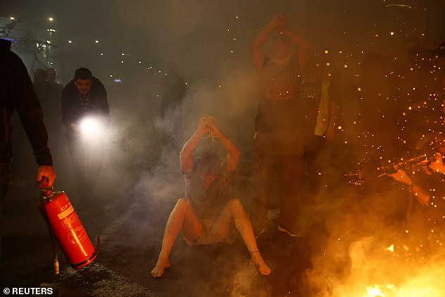 Protesters lit bonfires and gagged themselves in protest of the government's failure to recover the hostages.