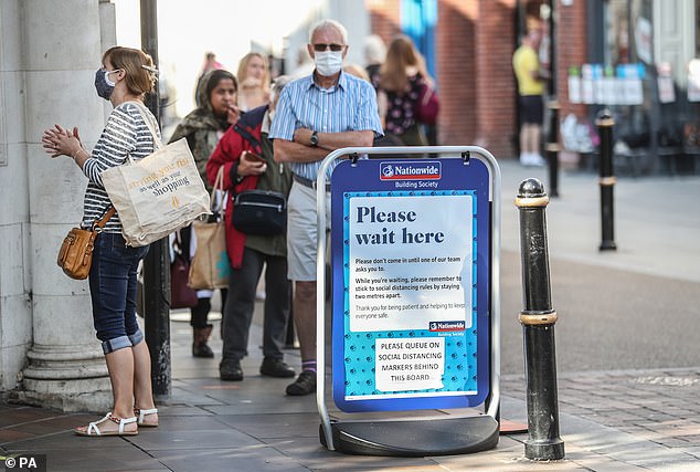 Customers queue socially distanced outside a Nationwide Building Society branch in Worcester in September 2020.