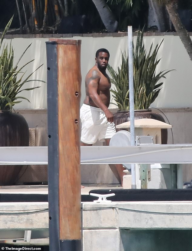 Diddy was photographed looking carefree as he went out for a smoke and a stroll along the pier in front of his Miami mansion, just days after the FBI sex trafficking raids.
