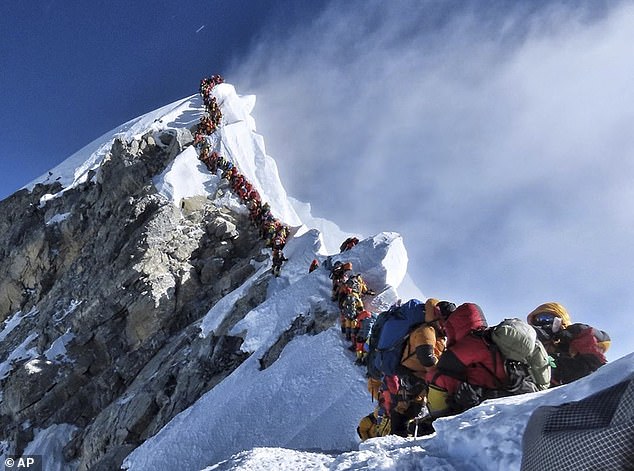 A long queue of climbers caused by overcrowding lines a path on Mount Everest in 2019