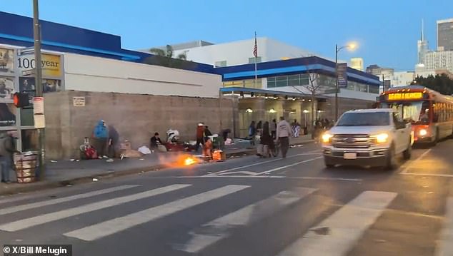 Footage shows dozens of homeless people sitting and standing on dirty sidewalks on the corner of San Pedro Street and 6th Street in the Skid Row neighborhood of Los Angeles.