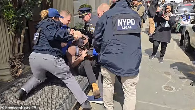 Dramatic moment NYPD pins protestor to the ground as crowd