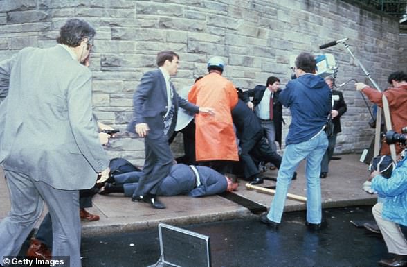 Chaos surrounds the shooting victims immediately following the attempted assassination of President Reagan, on March 30, 1981, by John Hinckley Jr. outside the Hilton Hotel in DC.