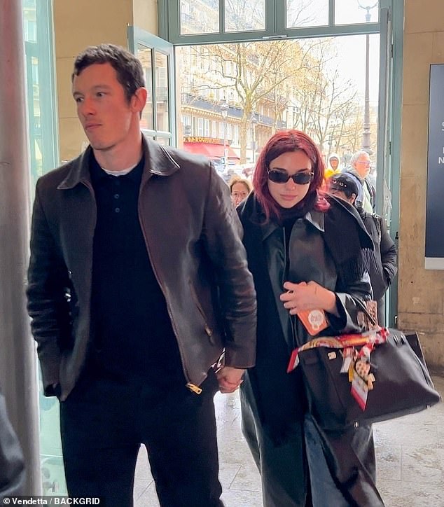 Dua Lipa and her boyfriend Callum Turner arrived hand in hand at a train station in Paris on Tuesday as they prepared to leave for London.