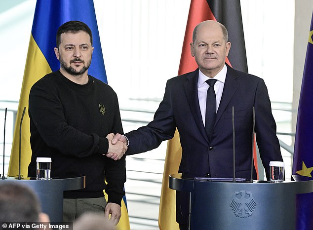 Ukrainian President Volodymyr Zelensky and German Chancellor Olaf Scholz shake hands after signing a security agreement last month.