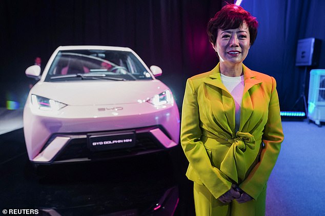 Australians are being warned about the safety risks of buying a Chinese-built electric car as the federal government moves to phase out petrol, diesel and even hybrid cars (pictured is BYD America director Stella Li with a BYD Dolphin)