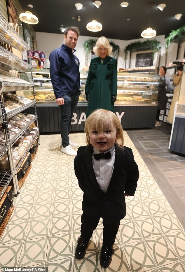 Fitz captured the nation's hearts yesterday as he donned a small tuxedo while his father William, co-owner of Knotts Bakery, chatted with Queen Camilla during her tour of Northern Ireland.