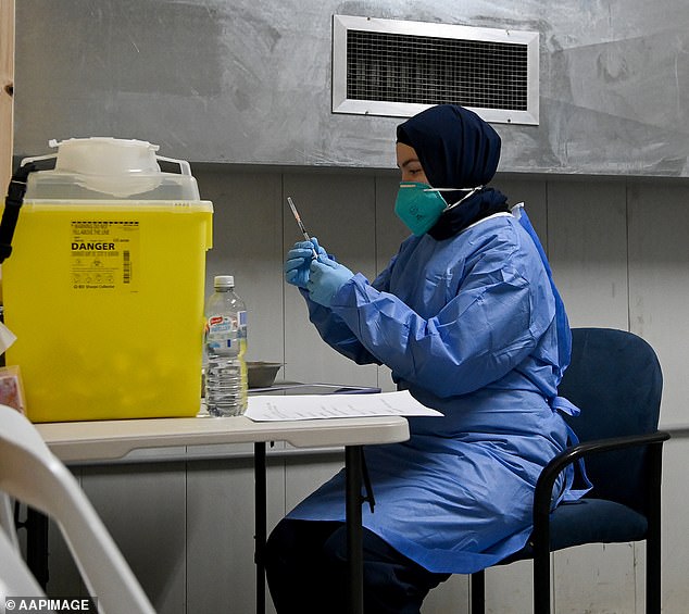 A Queensland court ruled that mandatory Covid vaccines for police in that state were illegal (pictured: a nurse prepared a vaccine dose in Sydney in 2021)