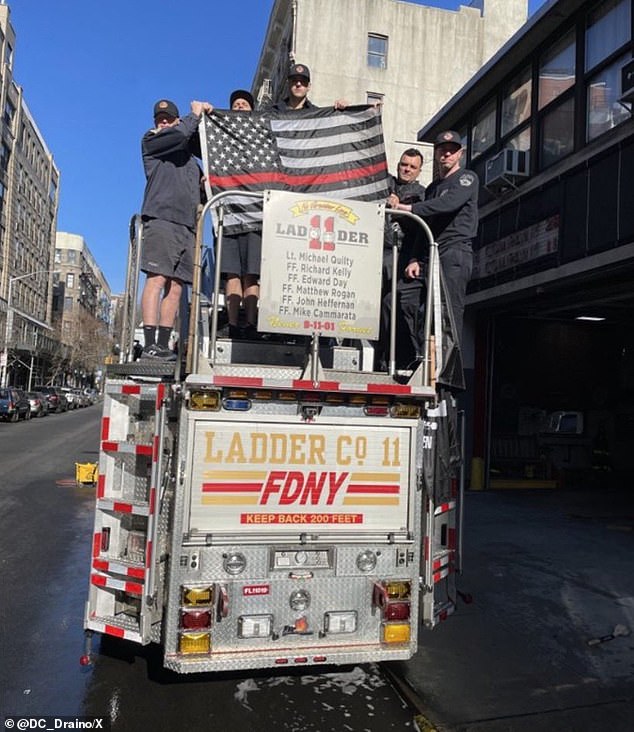 Lower East Side Ladder Company 11 displays its thin red line flag to honor the six men from its company who died fighting fires at the World Trade Center on 9/11.