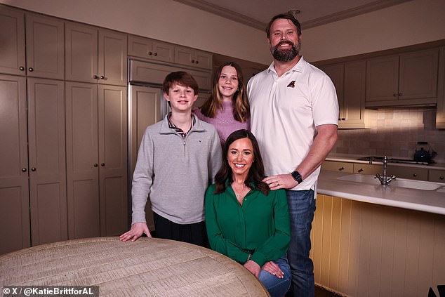 Britt appeared on the verge of tears at times as she tore into the policies President Biden emphatically defended and made an emotional appeal.  The picture: Britt with her husband and two children at the family kitchen table