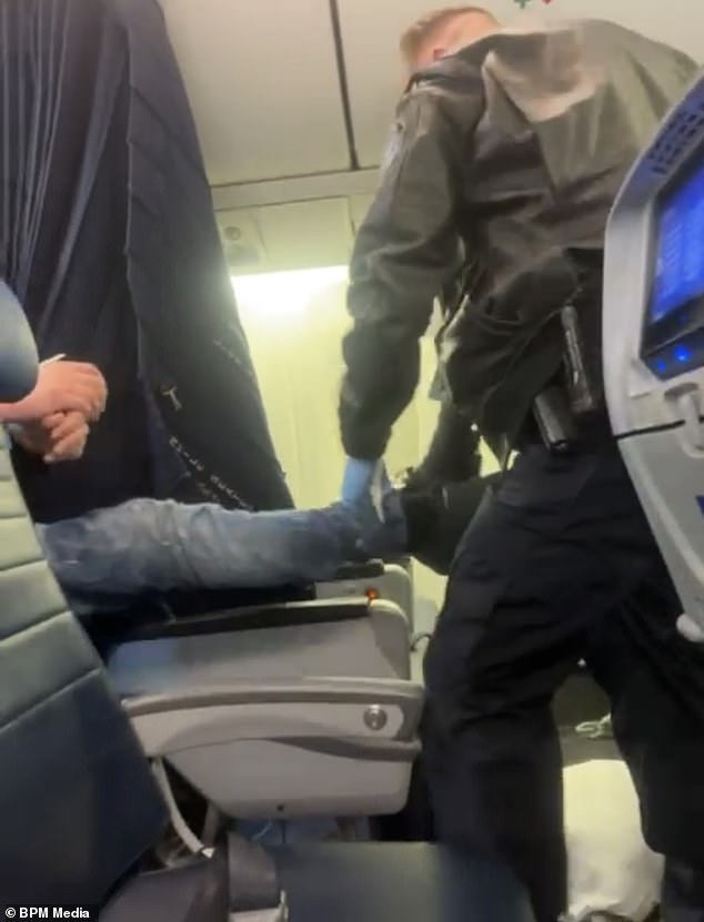 Border police pulled the man off the plane in Maine in front of cheering passengers after the flight was diverted.