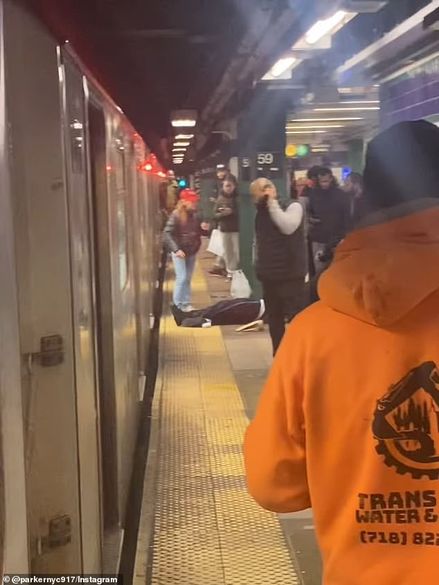 Wild footage captured the moment a determined subway user dragged the unconscious body of a passenger off a train surrounded by commuters.