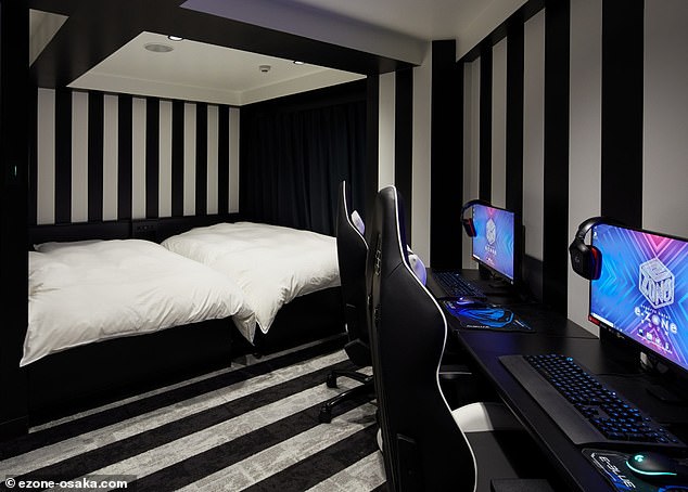 Pictured is a private twin room in the hotel, equipped with gaming computers for each person.