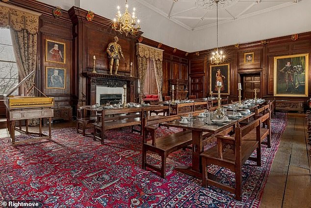 The interior of the castle includes high ceilings, wood-paneled walls and large fireplaces.