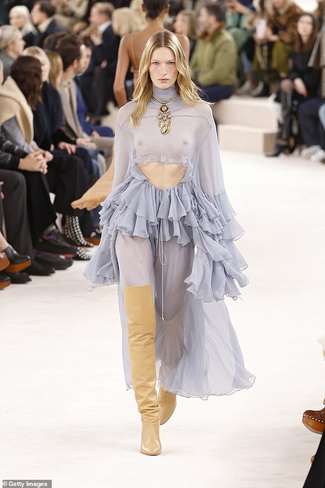 A model walks the runway in a sheer, ruffled, midriff-slit dress during designer Chemena Kamali's debut collection for Chloe.