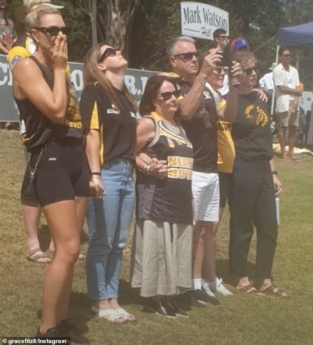 The Fitzgibbon family stood together in silent tribute for Lance Corporal Jack Fitzgibbon during a tribute at local Cessnock Football Club on Saturday
