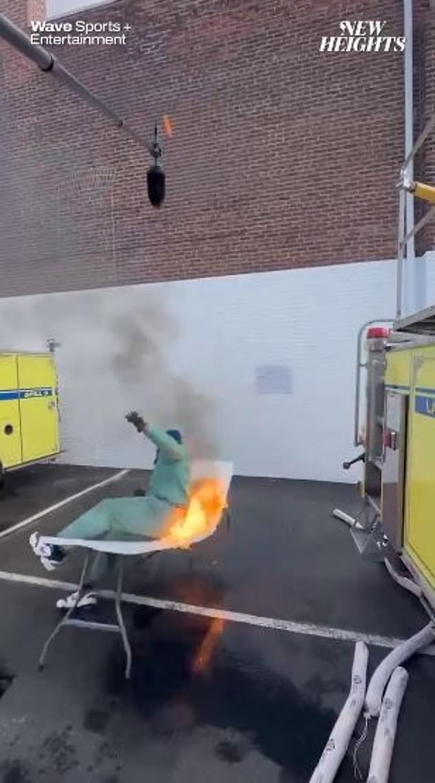 Kelce jumped from the fire truck through a burning folding table in a protective suit.