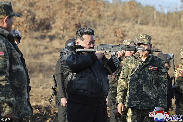 Kim Jong GUN Leather clad North Korean dictator brandishes assault rifle as