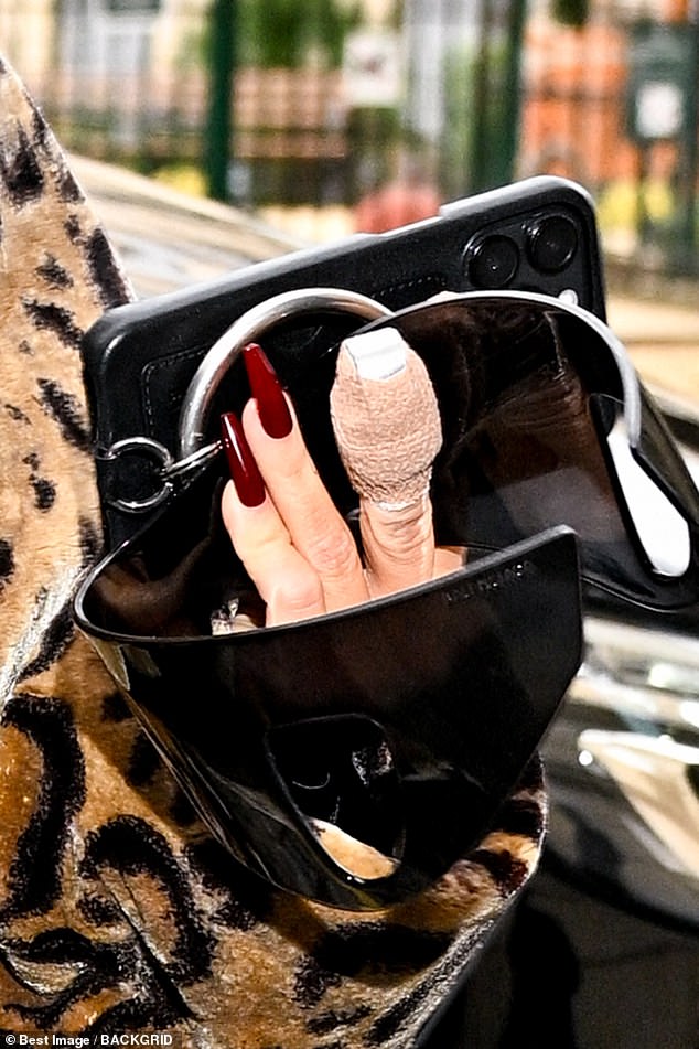The reality TV star, 43, stepped out with bandages around two of her fingers as she headed to lunch at Costes on Sunday.