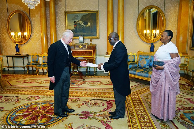King Charles met the ambassadors of Burundi and Moldova at Buckingham Palace today as the Queen stood in for him at the annual Royal Holy Service.  Above: The King greets the ambassador of Burundi, Epimeni Bapfinda