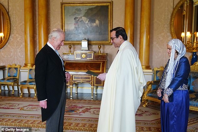 The King and the Algerian ambassador, Nourredine Yazid, appear to share a joke at Buckingham Palace