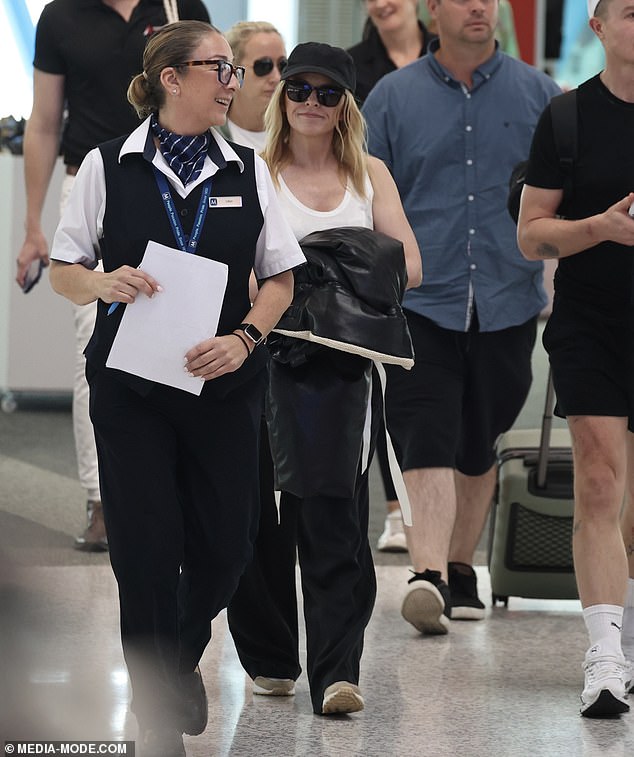 Kylie Minogue showed off her ageless face on Saturday as she landed at Sydney Airport after enjoying a 'mini break' in Queensland.