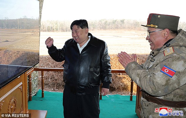 Leather clad Kim Jong Un pumps fist as he supervises very