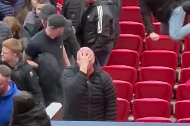 The Manchester United fan who made sick 'closing' and 'pushing' gestures to mock the Hillsborough disaster during Liverpool's FA Cup defeat at Old Trafford has been charged.