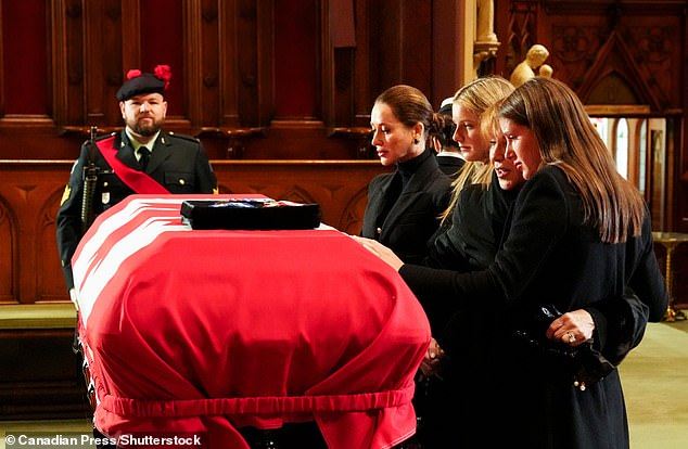 Jessica Mulroney, from left, Miranda Lapham, Mila Mulroney and Theodora Lapham take a moment before the casket of Brian Mulroney, former Canadian prime minister, at St. Patrick's Basilica in Montreal.