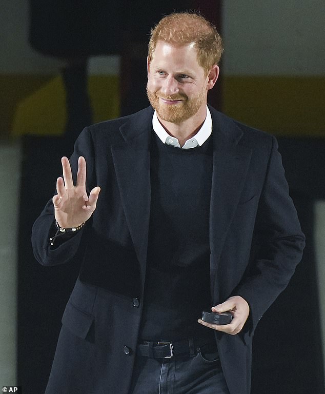The Duke of Sussex waves to the crowd as he arrives to toss the puck during a ceremonial faceoff at an NHL ice hockey game in Vancouver last year.