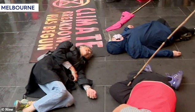 Climate change activists in Melbourne spread out across the footpath and pretended to play dead on Wednesday
