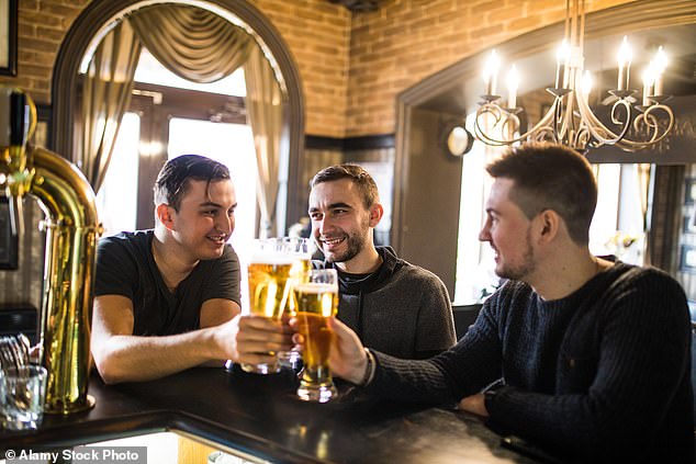 A group of men drinking pints of beer in a pub.  Men should abstain from drinking for at least three months before trying to have a baby after discovering that the effects of alcohol consumption take longer than previously thought to leave the father's sperm (file image)