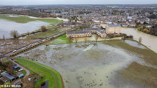 The Met Office confirms that last month was the hottest February on record in England and Wales, and one of the wettest on record.  Pictured: Fields filled with flood water after the River Great Ouse at St Ives, Cambs, burst its banks in February.
