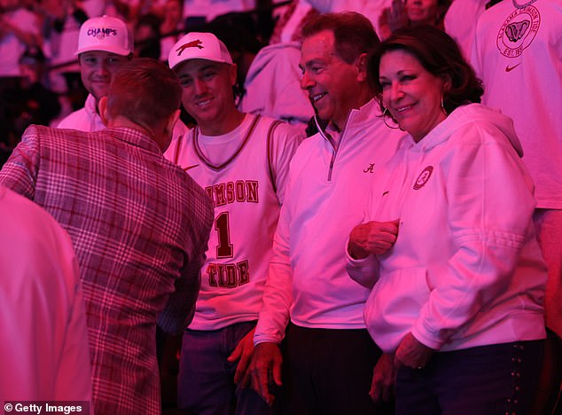 Former Alabama golfer Justin Thomas (left) greets basketball coach Nate Oats alongside Nick Saban and his wife, Terry, before a basketball game against Tennessee on March 2.
