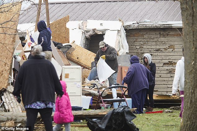 Families and neighbors help each other clean up after a tornado hit the Indian Lake, Ohio area