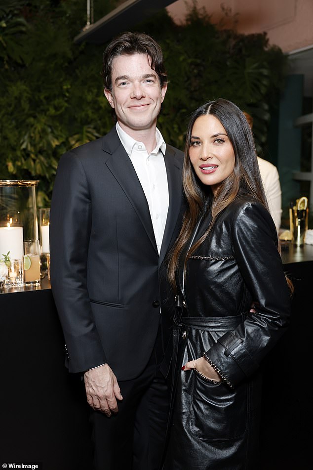 Olivia Munn and John Mulaney looked happy as can be on Saturday night.  The power couple were spotted hugging at CHANEL and Charles Finch's annual pre-Oscar Dinner at The Polo Lounge at The Beverly Hills Hotel