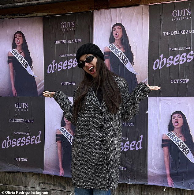 Rodrigo was later seen posing in front of four promotional posters for the updated version of Guts in another snapshot.
