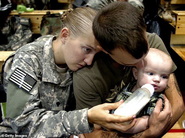 A member of the 82nd Airborne Division feeds his five-month-old child at Fort Bragg, North Carolina, where poverty, hardship and food insecurity are common.