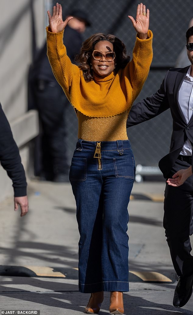Oprah Winfrey showed off her dramatically slim waist in a skintight orange outfit while out and about in Hollywood this week