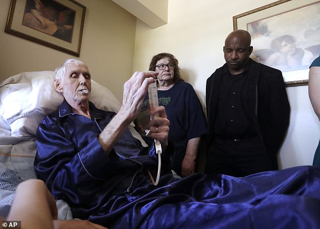 Physician-assisted suicide plans are available in all three West Coast states.  Pictured: Robert Fuller begins to insert the medications that will end his life into his feeding tube in Seattle, Washington.