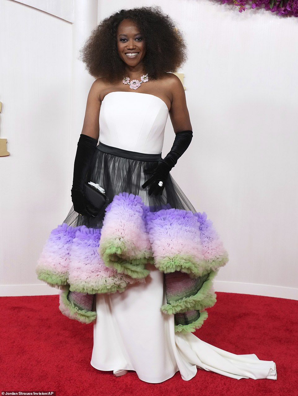 Cosby Show star Erika Alexander wore what would have been a very elegant white dress - had it not been for the huge black, purple, pink and green tutu-style skirt that cinched around her waist