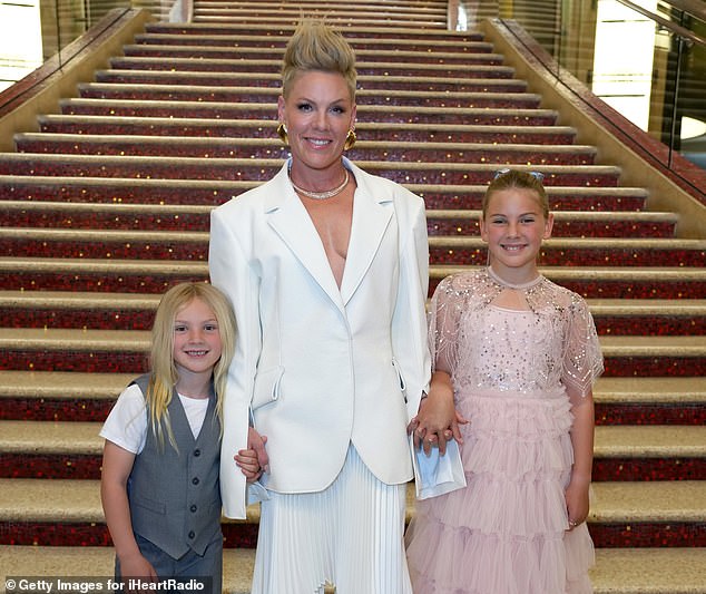 Pink, 44, may be a global pop superstar, but she proved on Saturday that her family is just like any other when she shared images of her children at her latest concert in Sydney.  Pictured with children Willow, 12, and Jameson, seven, last year