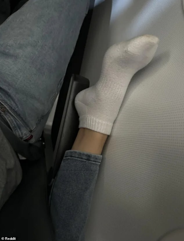 A passenger sparked furious outrage after revealing a fellow passenger put his feet on his armrest.