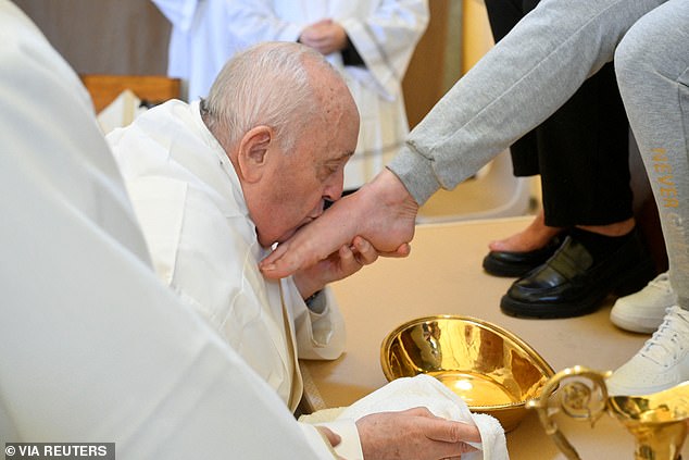 Pope Francis kisses the feet of an inmate from the female section of the Rebibbia prison during a Holy Thursday ritual