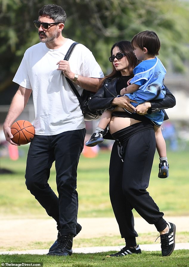 Jenna Dewan, 43, proudly showed off her growing baby bump in a casual ensemble as she stepped out with fiance Steve Kazee, 48, and their son Callum, four, in Los Angeles on Saturday