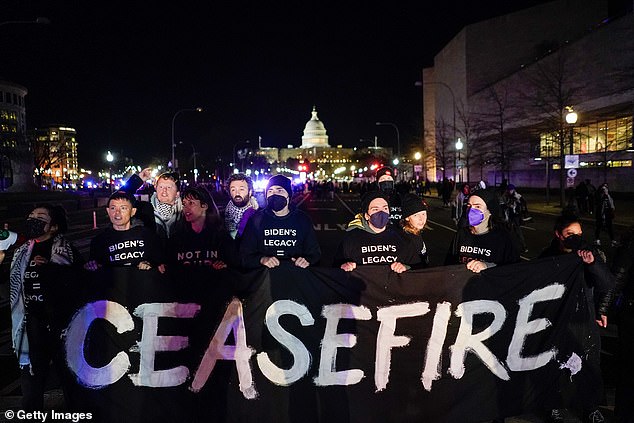 Pro-Palestinian protesters stand in the middle of the street in an attempt to block President Joe Biden's motorcade between the White House and the Capitol for his State of the Union address Thursday night.  Pictured: Jewish Voice for Peace activists join a pro-Palestinian protest on Pennsylvania Avenue on March 7, 2024.