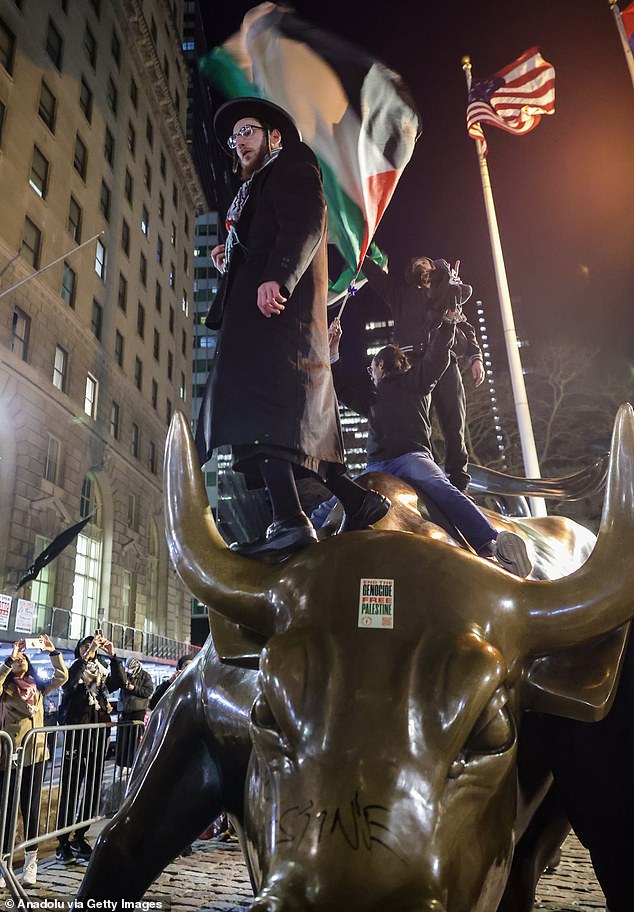 Pro Palestinian protesters ride the famous Wall Street Bull and dare